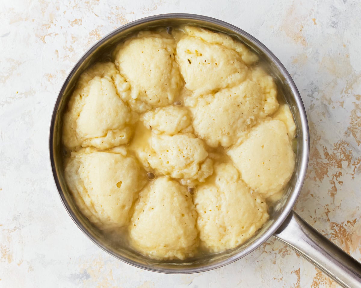 Gluten-free chicken and dumplings cooking in a pan