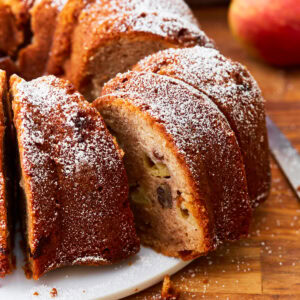 A close up of a sliced gluten-free apple cake.