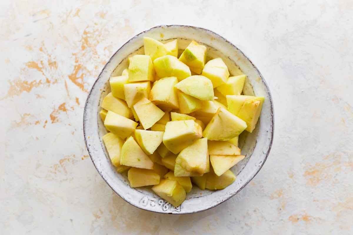 Peeled and chopped apples in a bowl.