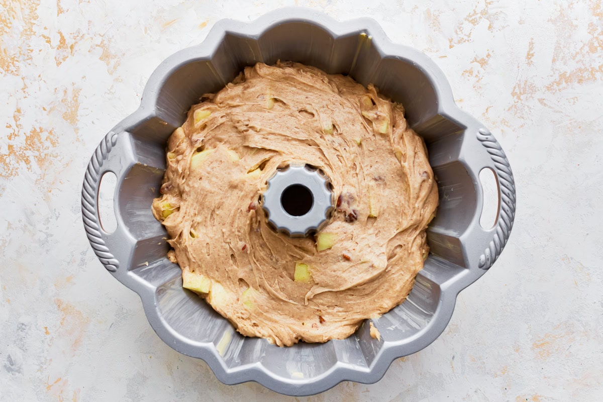 Gluten-free apple cake batter in a bundt pan.