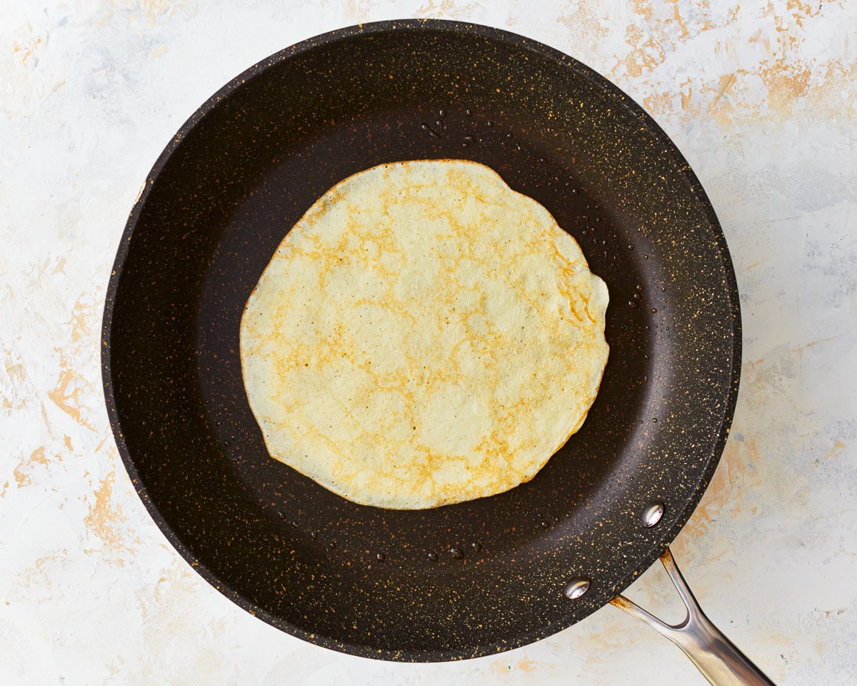 a cooked gluten free crepe in a pan.