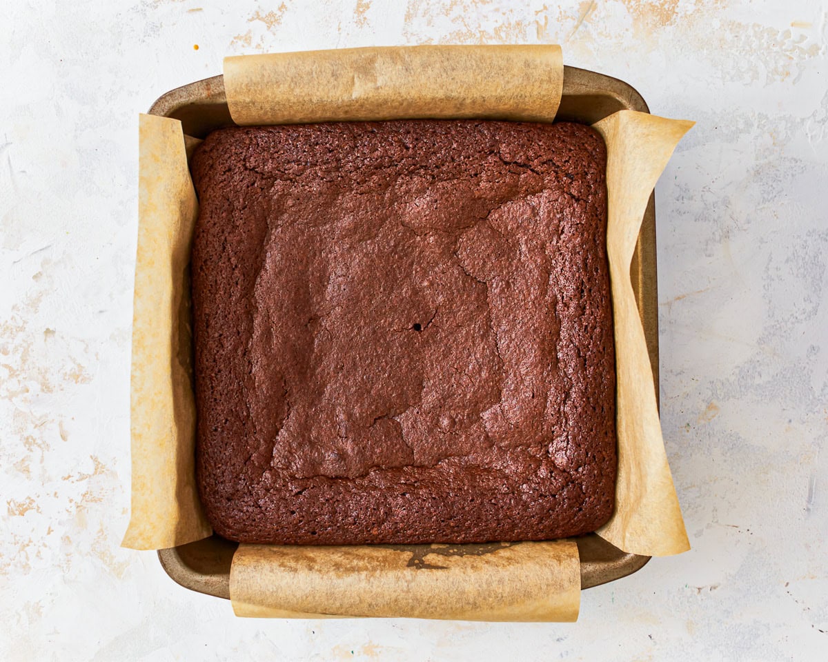 gluten free brownies in a lined square baking pan.
