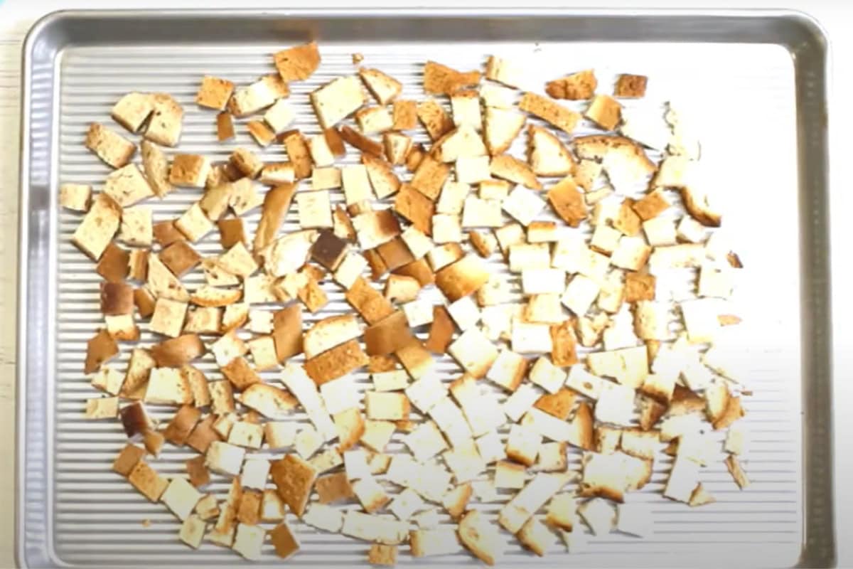 Gluten-free bread cubes on a baking sheet.