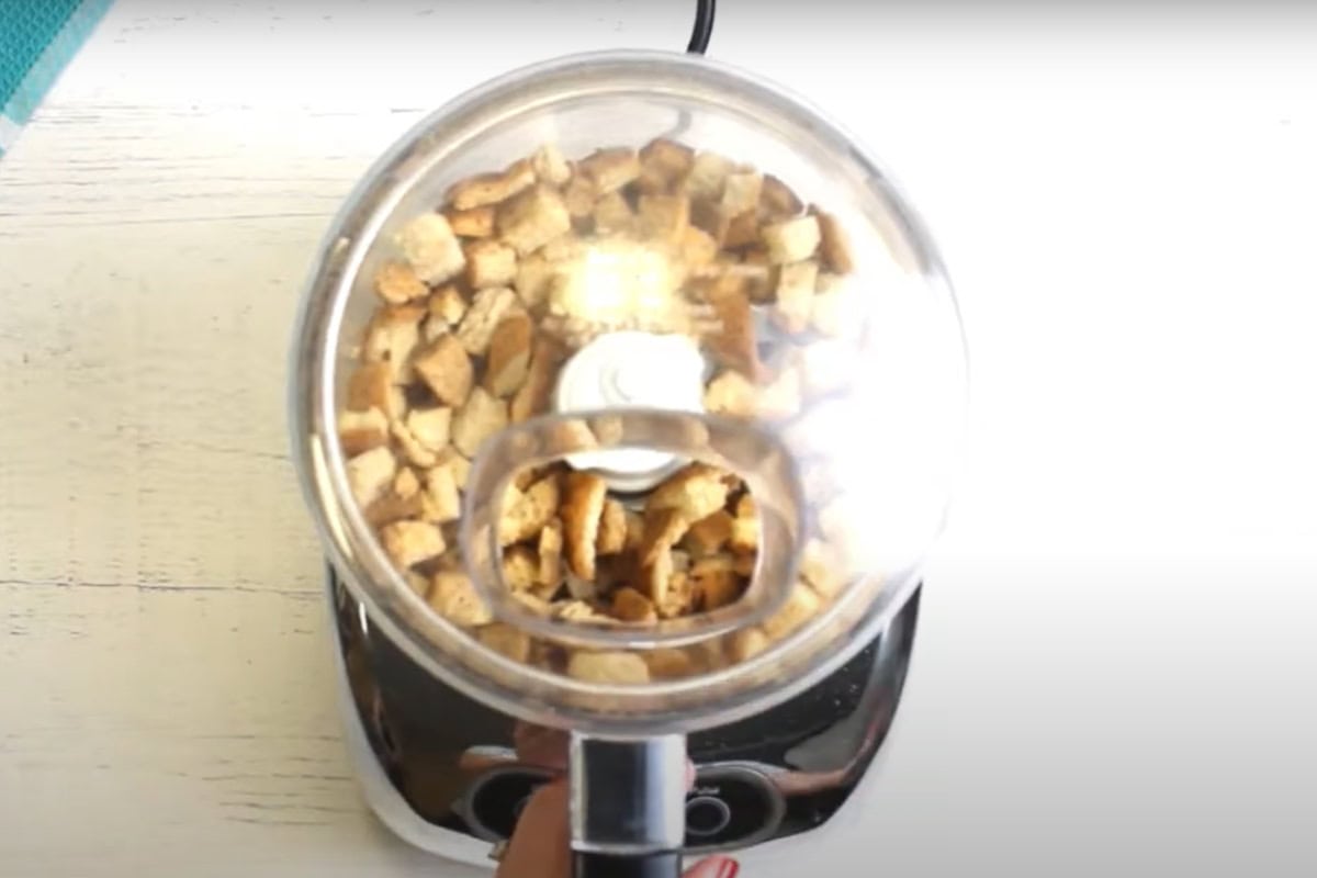 Gluten-free bread cubes in a food processor.