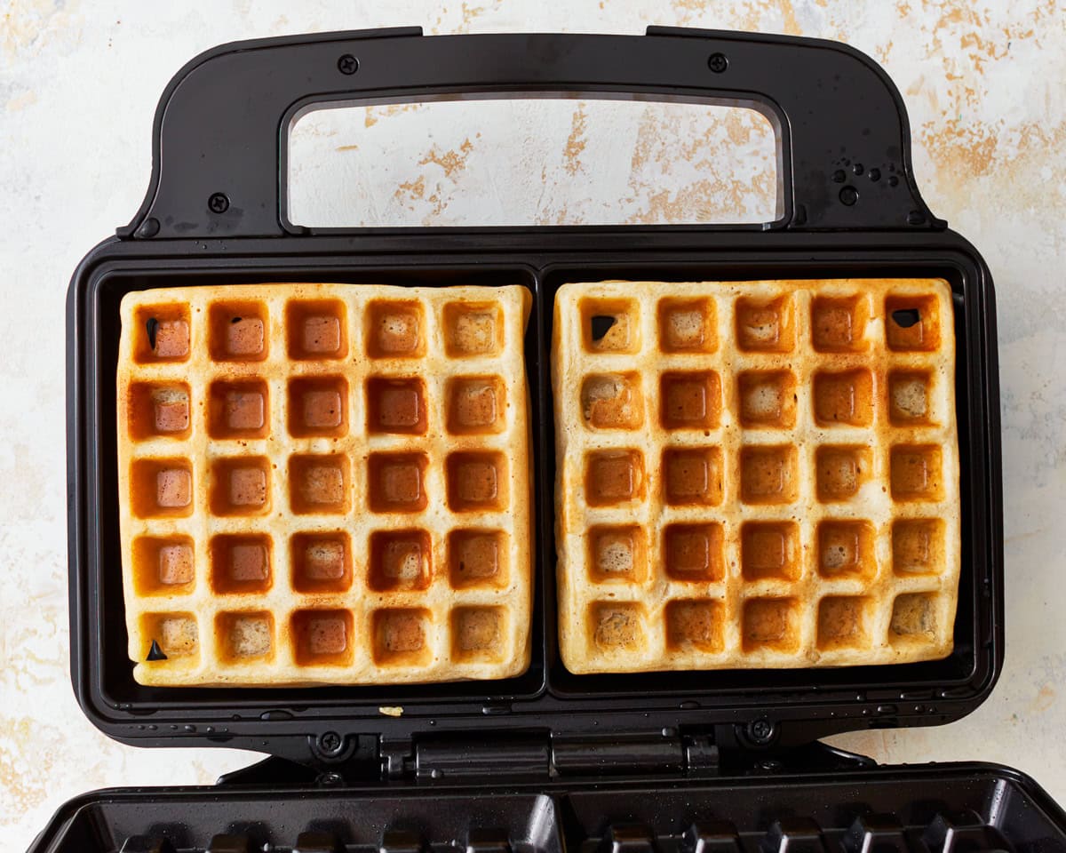 cooked gluten-free waffles in a waffle iron.