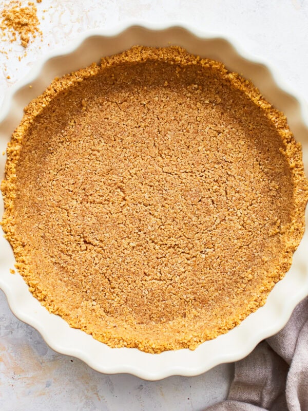 Overhead view of a gluten-free graham cracker crust in a pie dish.