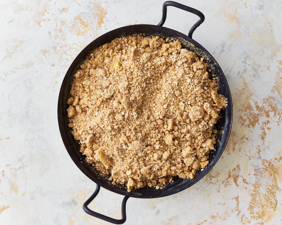 Gluten-free apple crisp in a baking dish ready to be baked