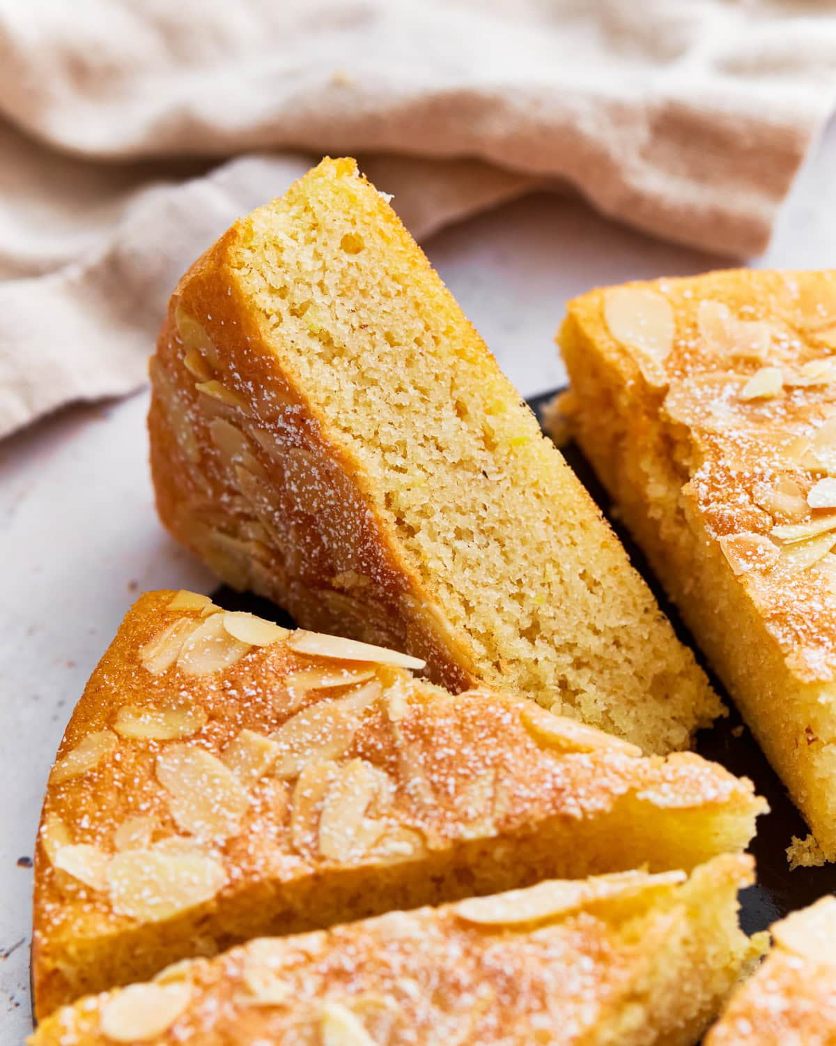 Slices of almond flour cake on a serving tray.