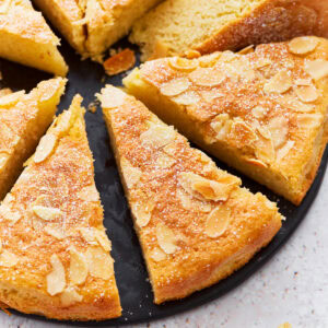 A close up of almond flour cake cut into slices.