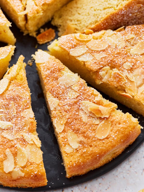 A close up of almond flour cake cut into slices.