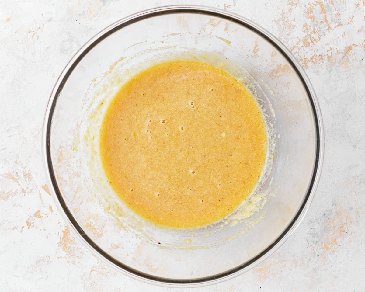 Almond flour cake batter in a glass mixing bowl.