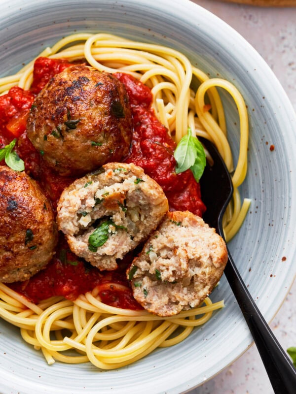 Gluten free turkey meatballs on a plate with spaghetti and marinara sauce