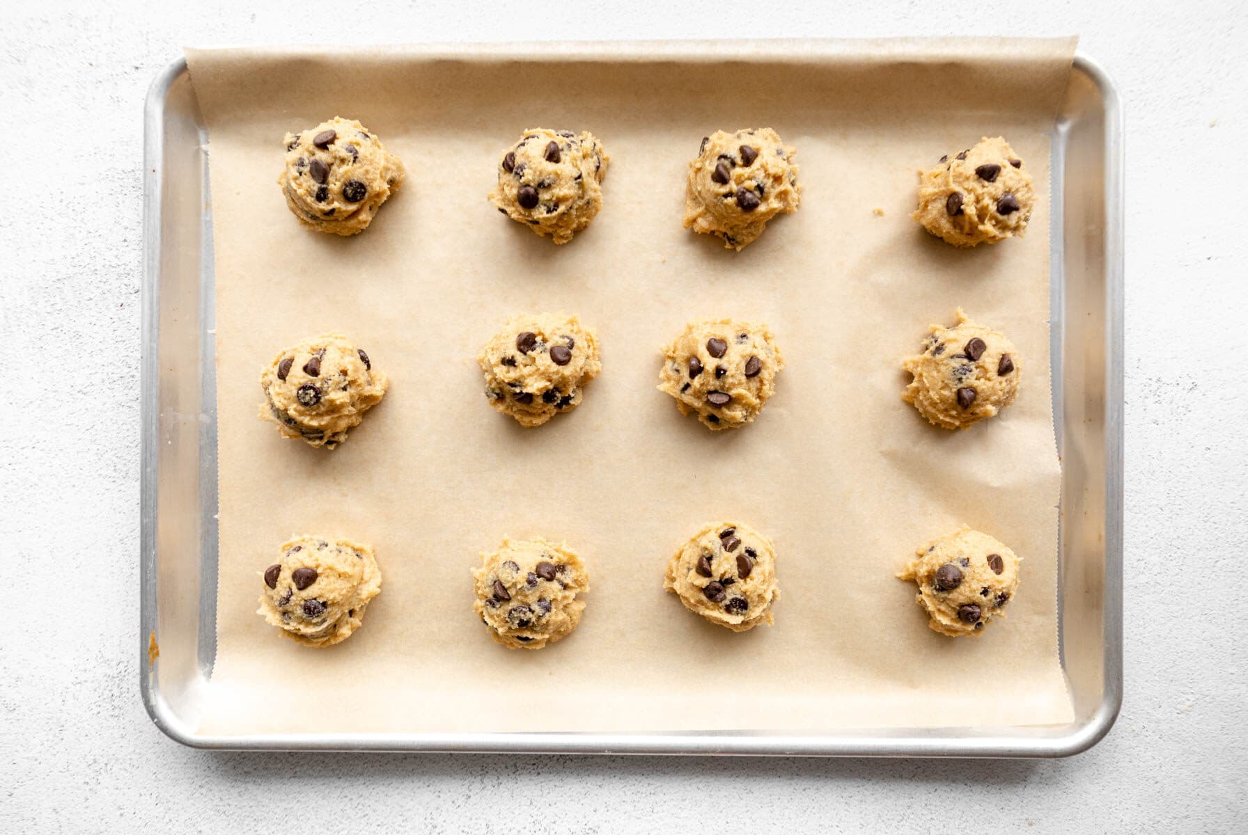 almond flour cookie dough balls on a baking sheet.