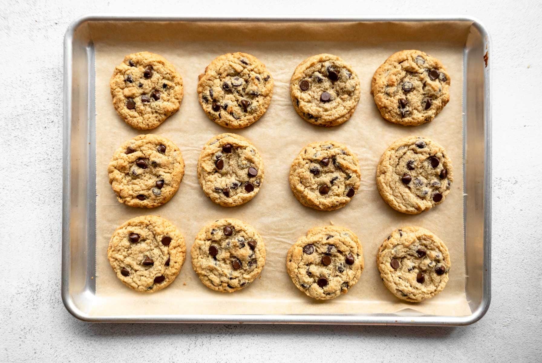baked almond flour chocolate chip cookies in a baking sheet.