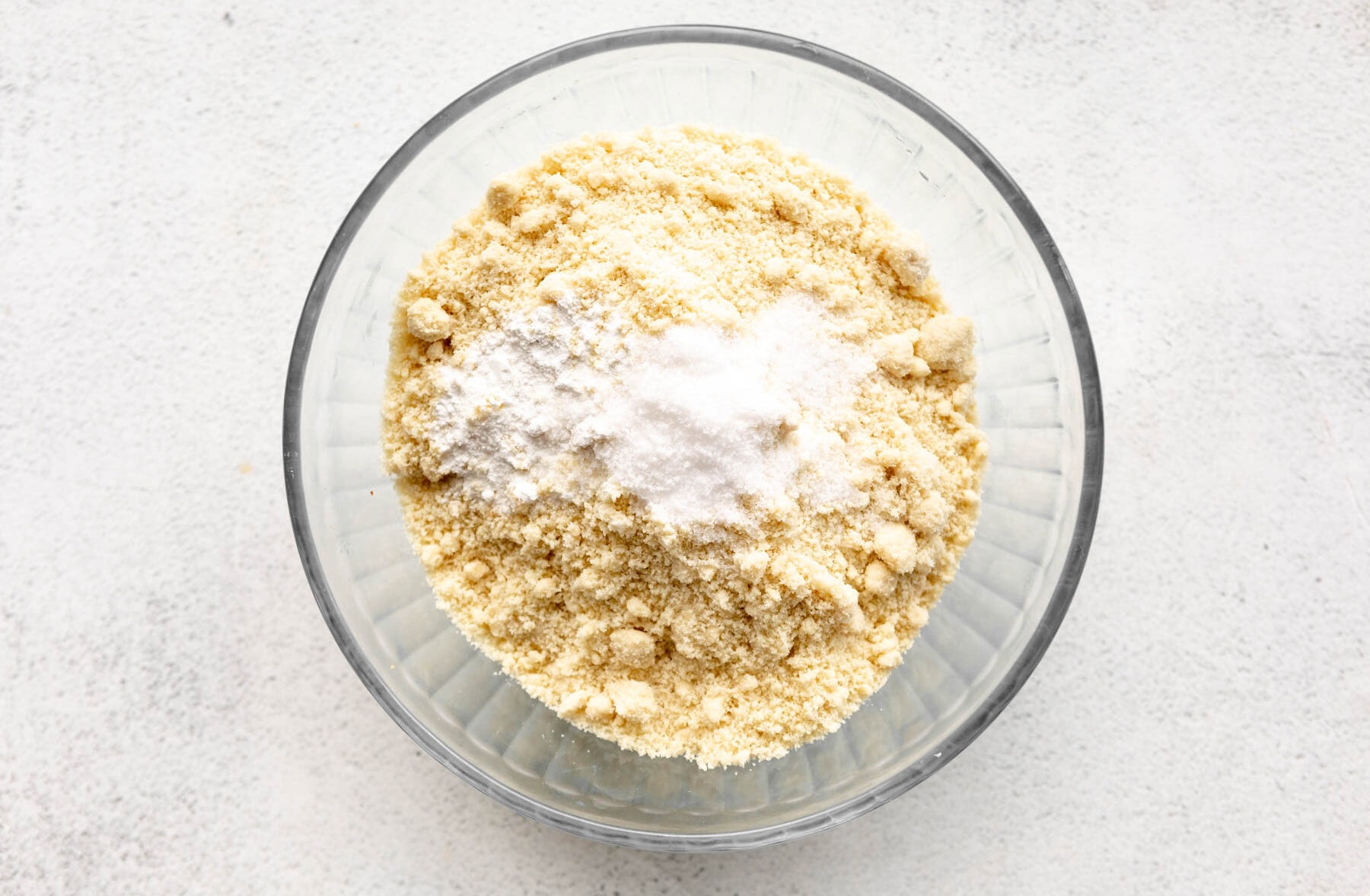 almond flour, baking soda, baking powder, and salt in a glass bowl.
