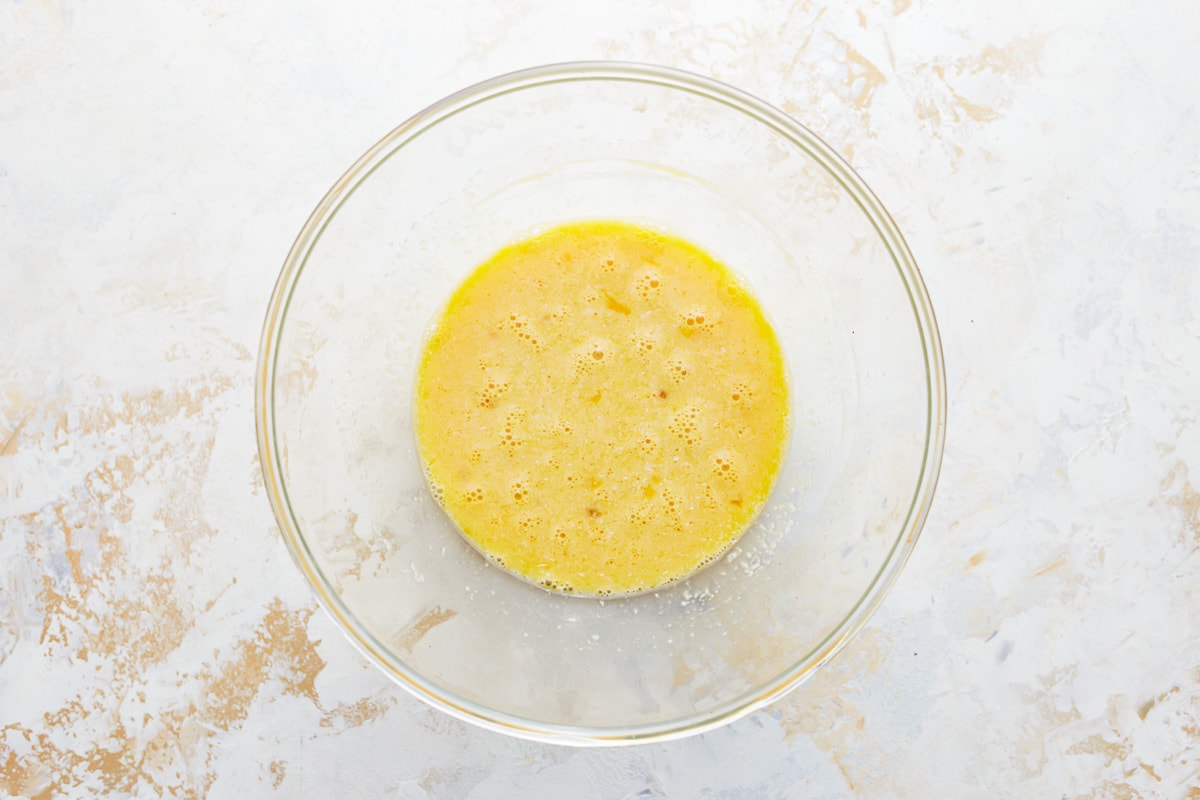 whisked eggs in a glass bowl.