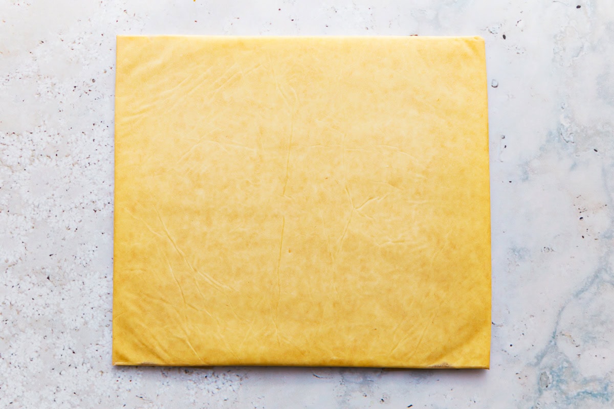 a slab of butter in parchment paper.