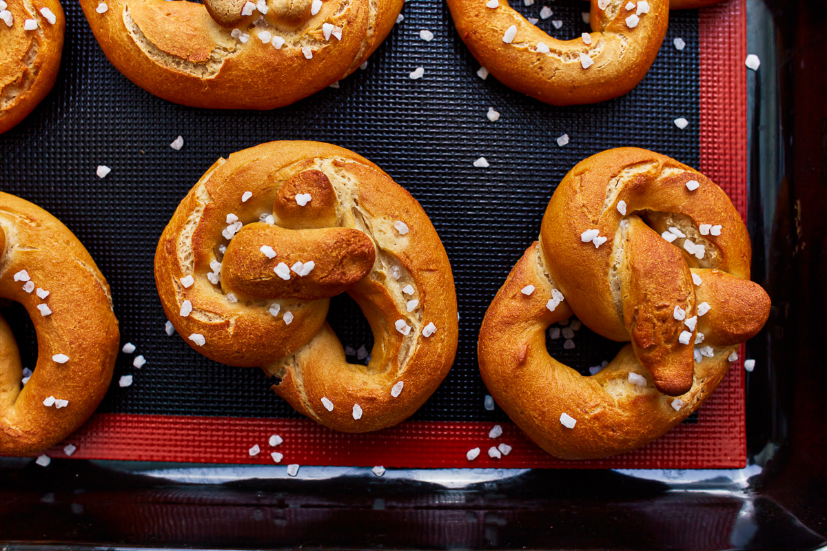 gluten free soft pretzels on a baking sheet.