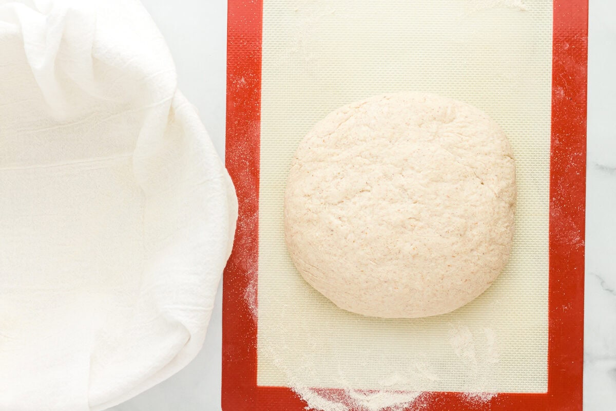 smooth gluten free sourdough bread dough on a cutting board.