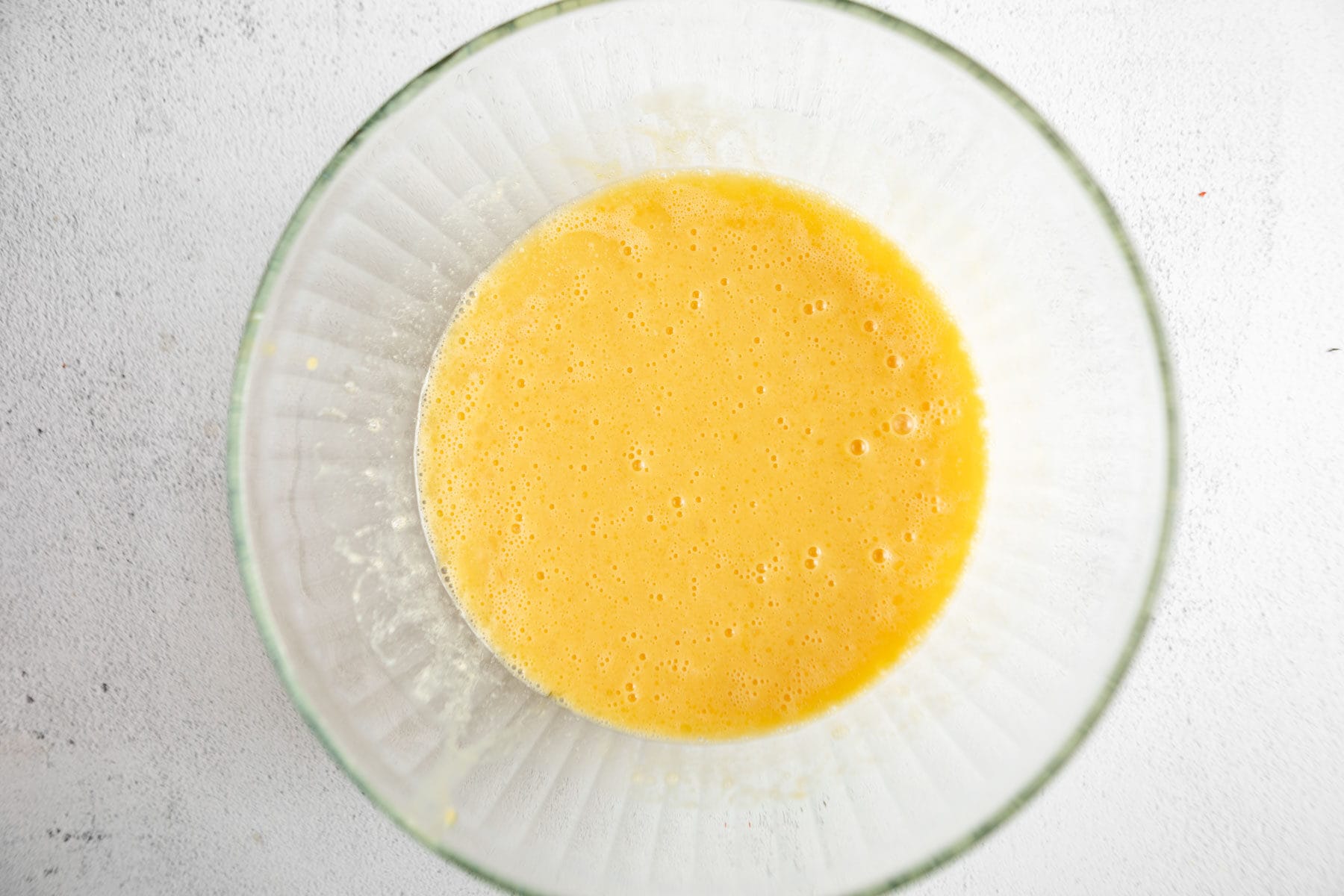 beaten eggs in a glass bowl.