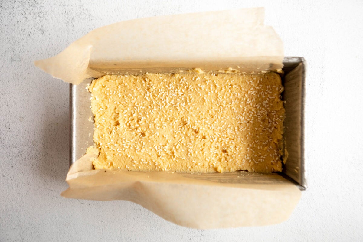 coconut flour bread dough in a lined loaf pan.