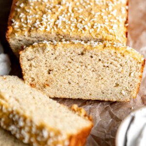 a partially sliced loaf of coconut flour bread.