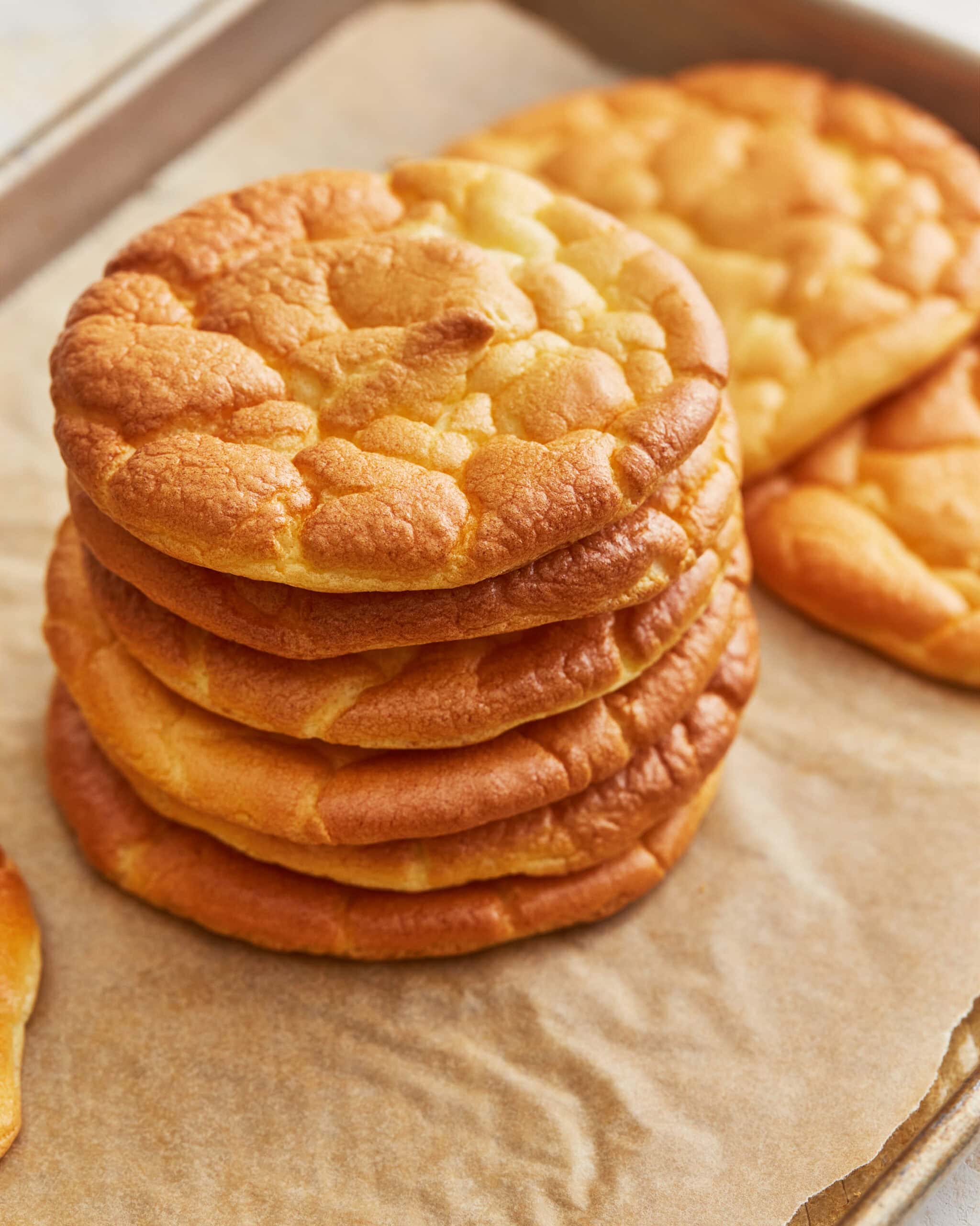 A stack of cloud bread on a parchment lined baking sheet.