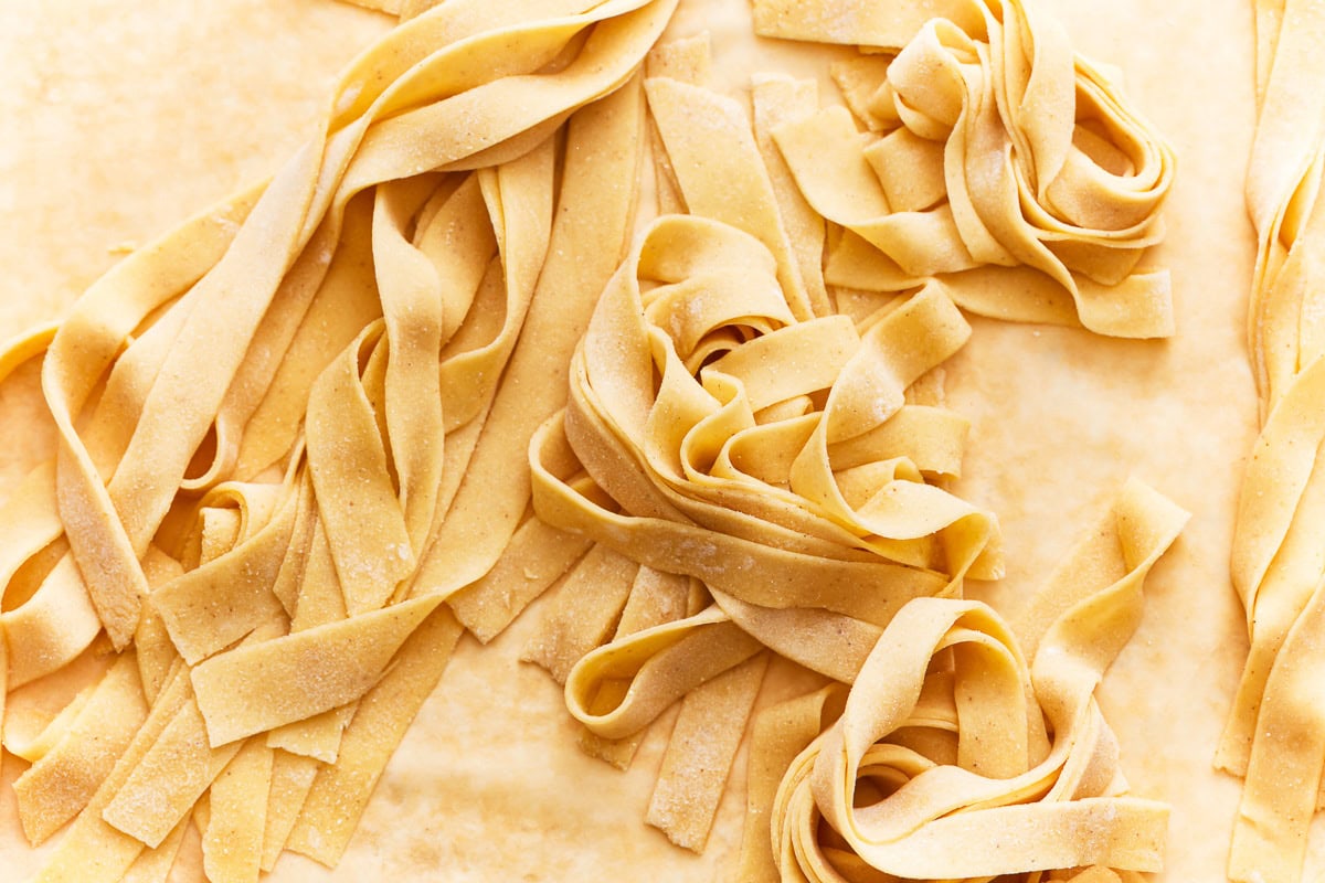 ribbons of gluten-free pasta on parchment paper.