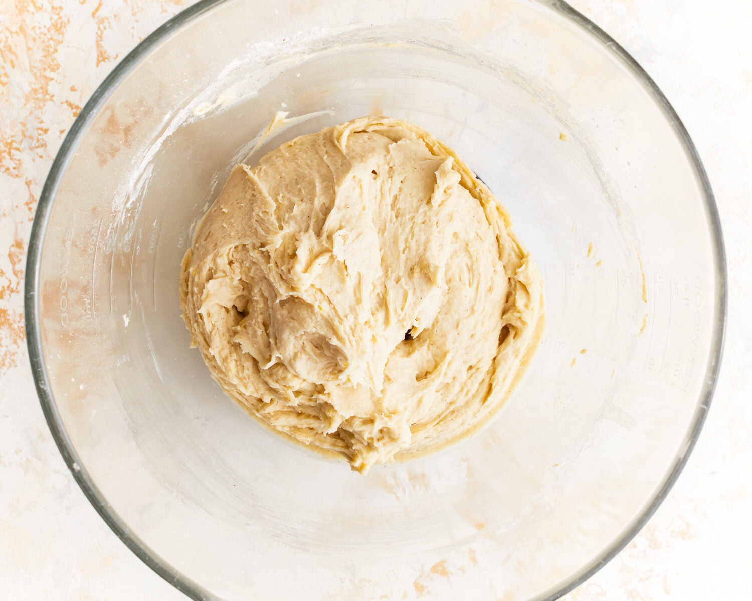 Sticky dough for gluten free potato bread in a glass mixing bowl.