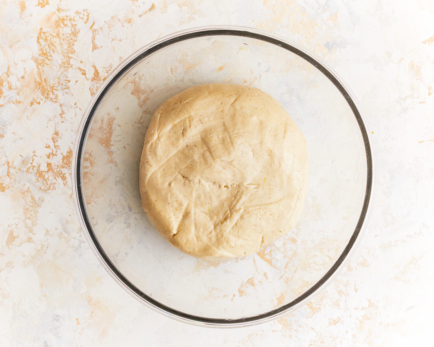 Smooth dough for gluten free potato bread in a glass mixing bowl.