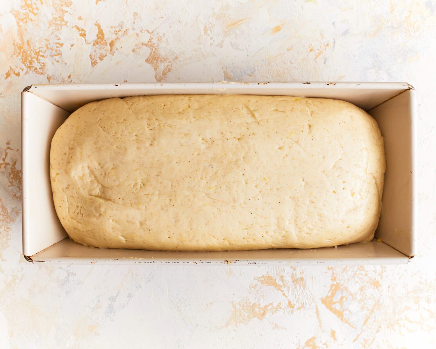 Dough for gluten free potato bread in a loaf pan.