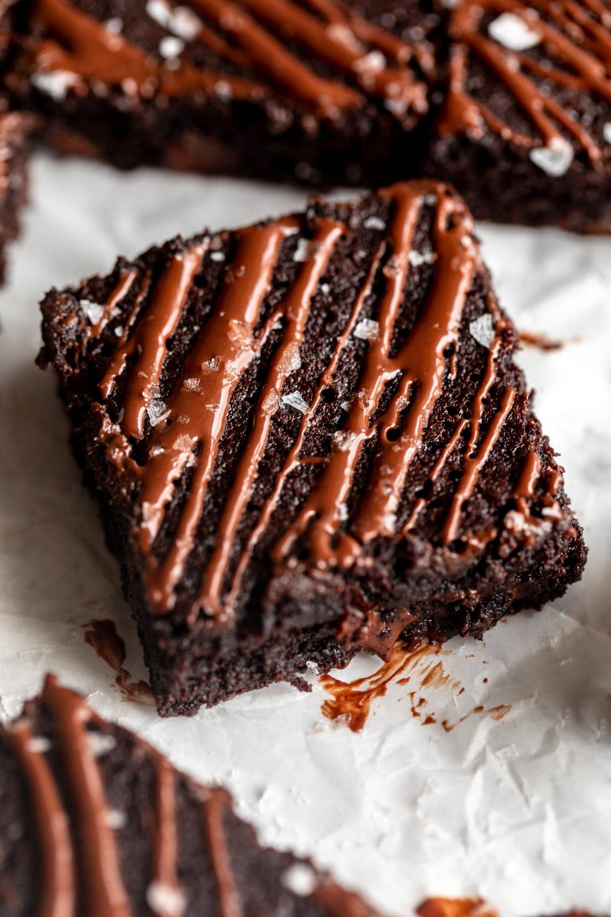 Coconut flour brownies on parchment paper.