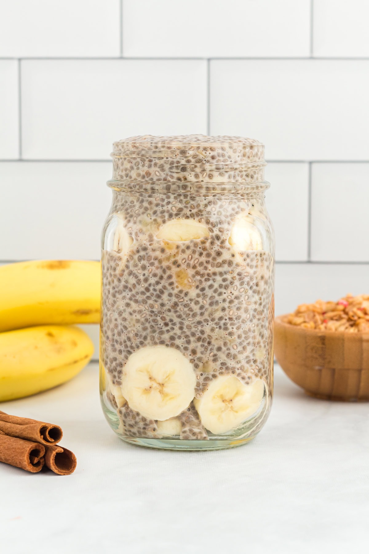 side view of banana chia pudding in a mason jar.