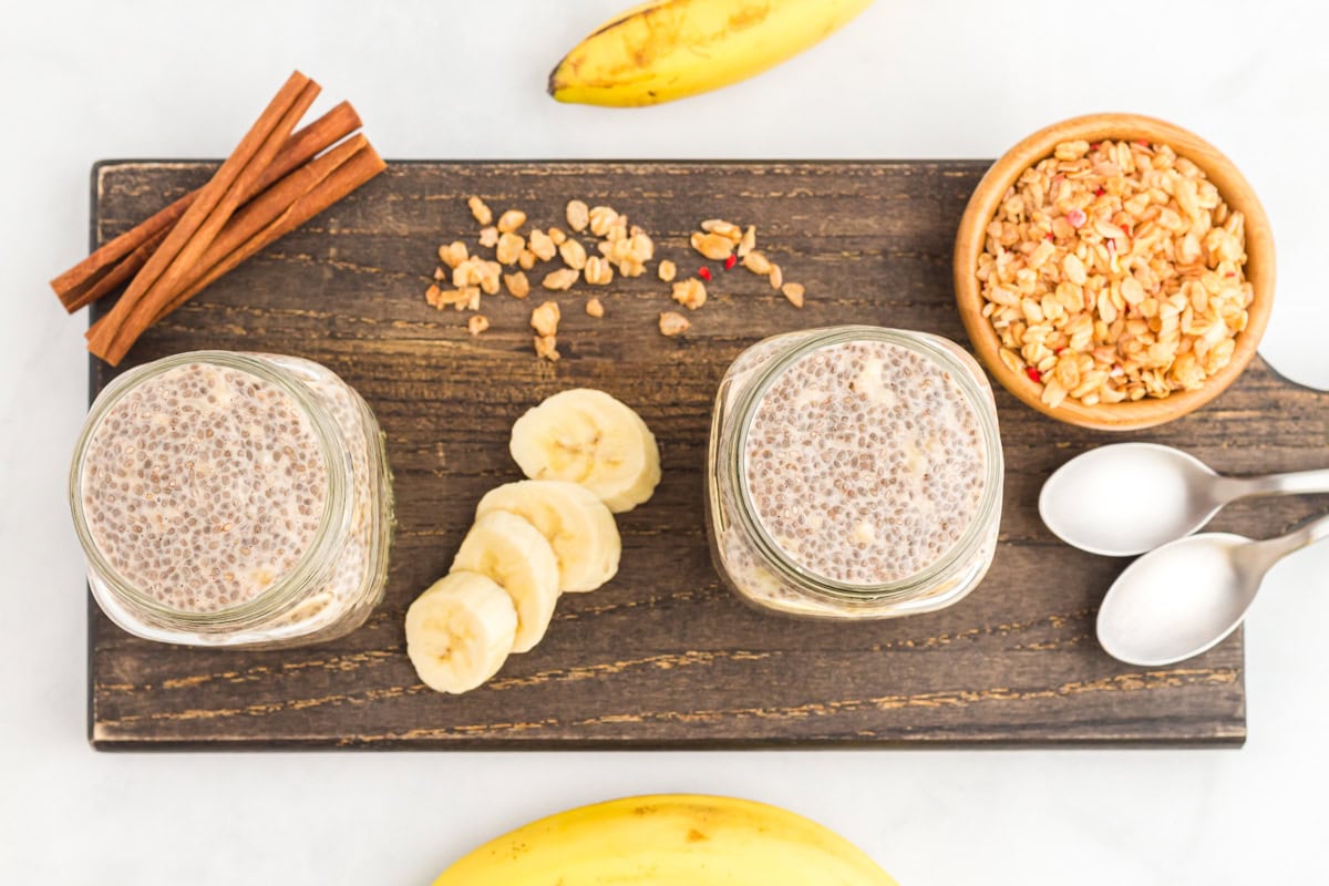 overhead view of 2 servings of banana chia pudding in mason jars.