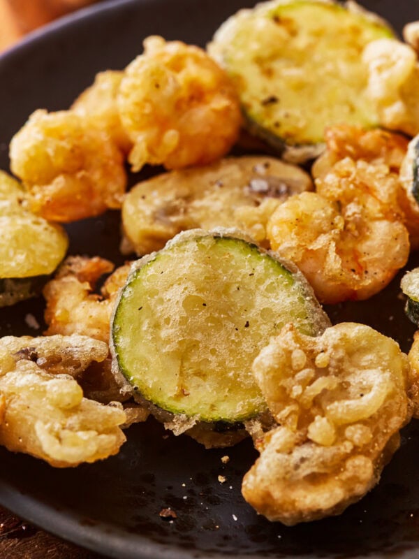 A plate of vegetables and shrimp cooked in a gluten free tempura batter.