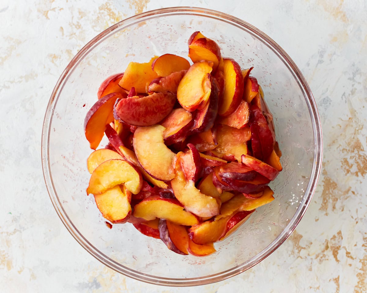 Sliced peaches in a bowl.