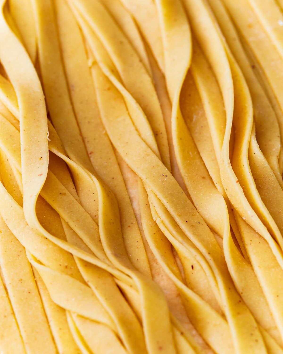 A close up of almond flour pasta dough shaped into strips