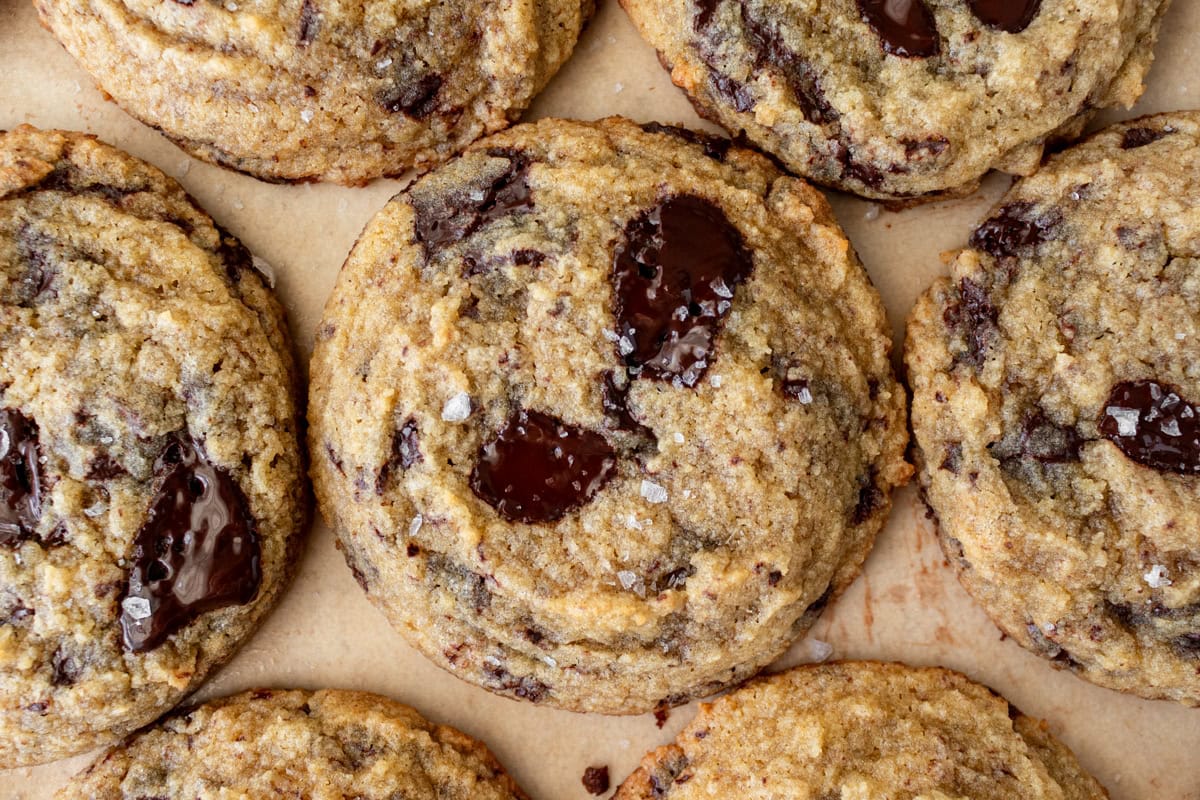 A close up of coconut flour chocolate chip cookies on a parchment lined baking sheet