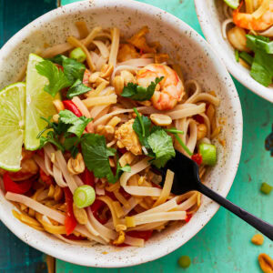 Gluten-free pad thai in a bowl with a fork