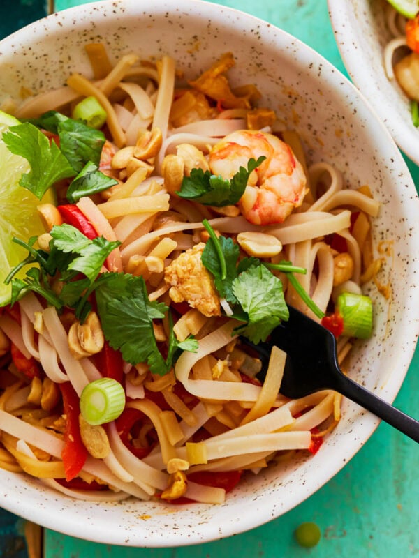 Gluten-free pad thai in a bowl with a fork