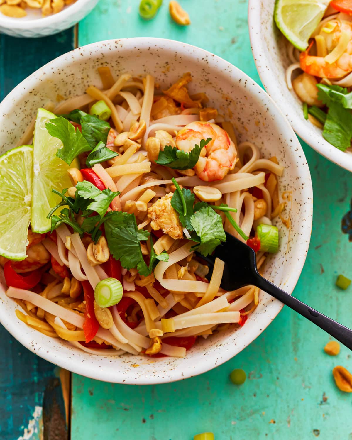 Gluten-free pad thai in a bowl with a fork