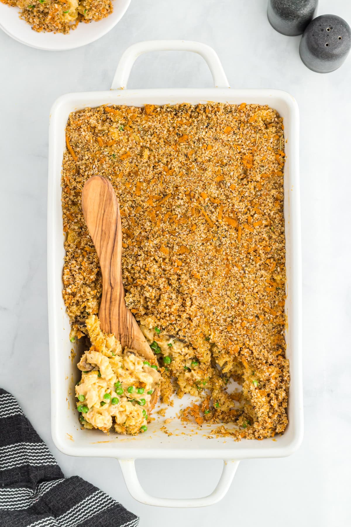 Gluten-free tuna casserole in a baking dish with a spoon