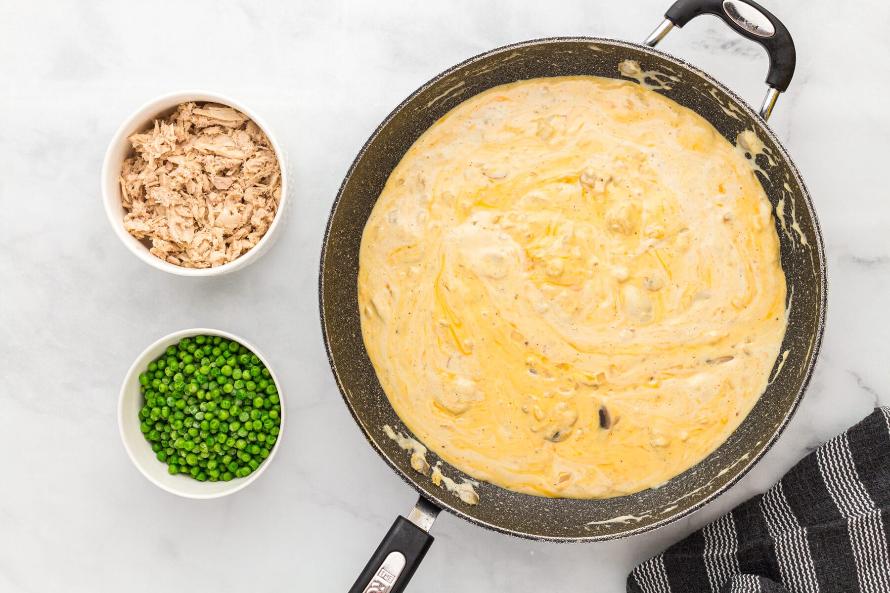 Cheesy sauce for gluten-free tuna casserole in a skillet