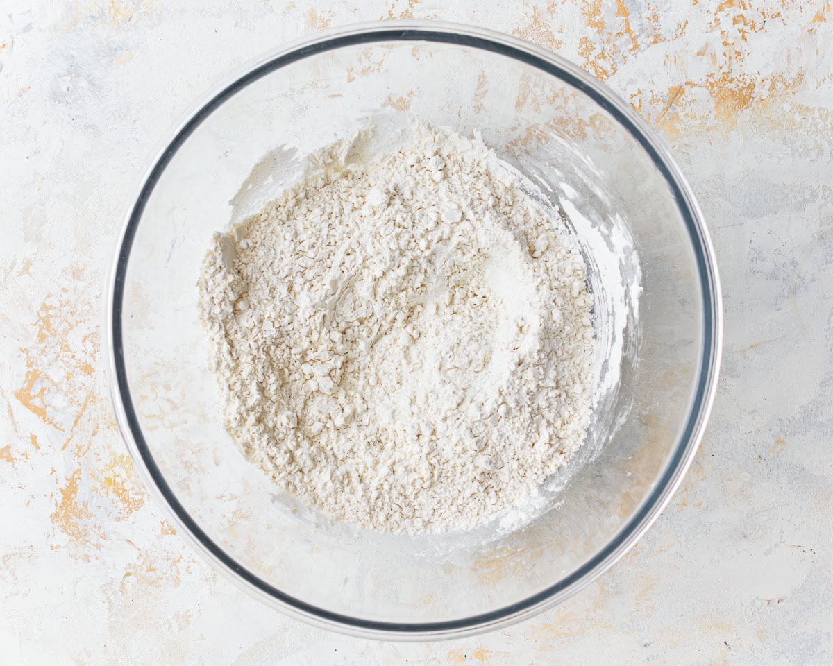 Dry ingredients for gluten-free egg noodles in a glass mixing bowl