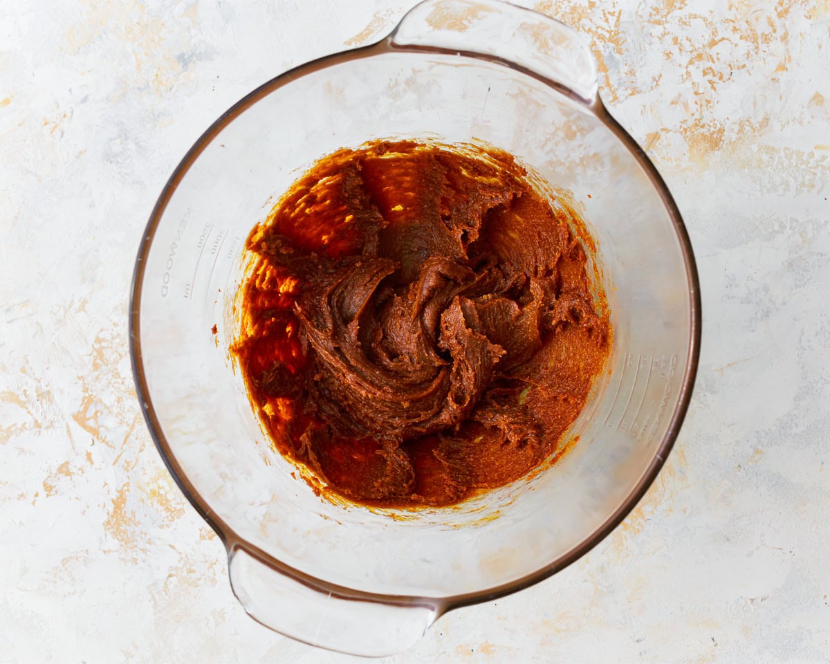 Brown sugar and egg base for gluten-free peanut butter oatmeal cookies in a mixing bowl