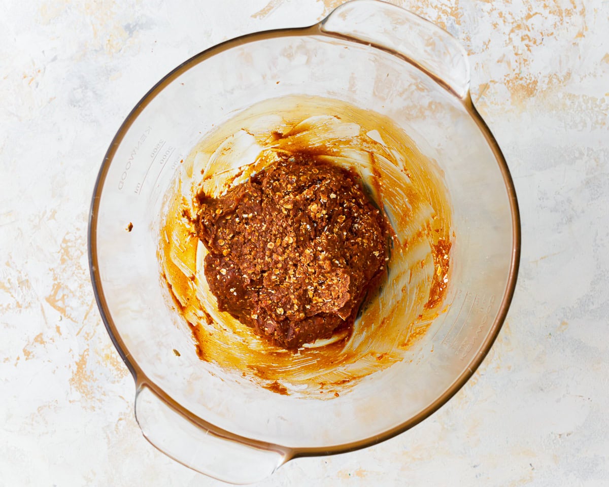 Gluten-free peanut butter oatmeal cookie dough in a glass mixing bowl