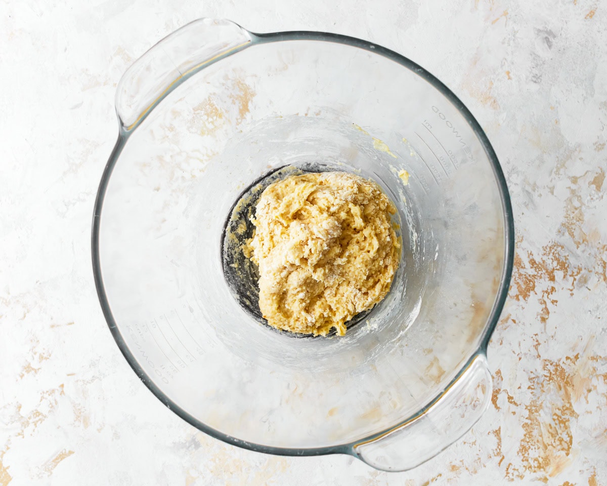 Mixed ingredients for almond flour pasta dough in a glass bowl