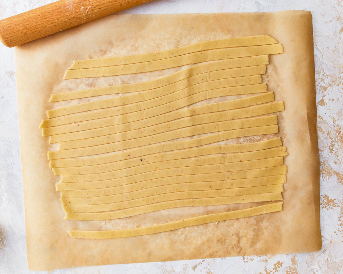 Almond flour pasta dough sliced into strips