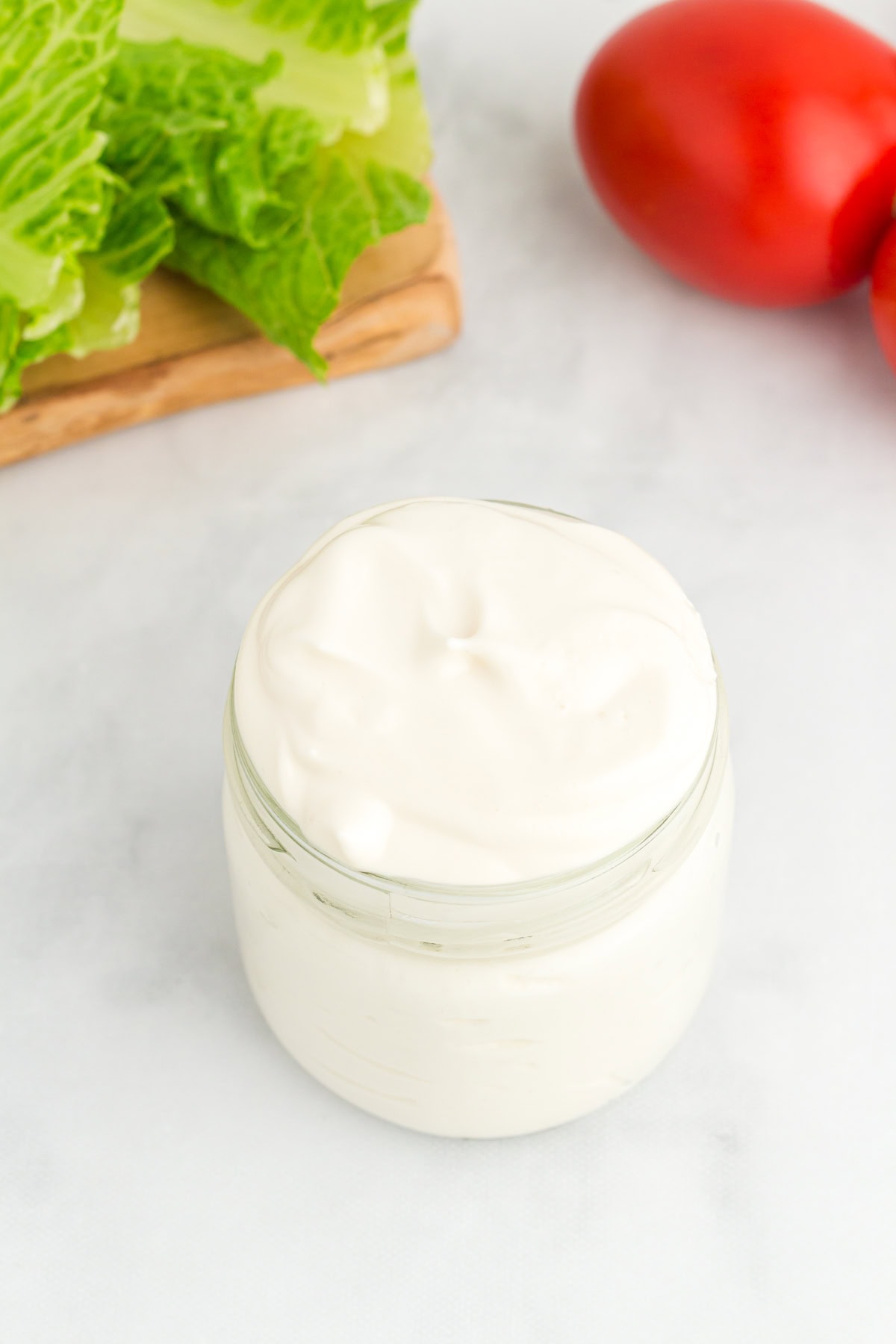 A glass jar of homemade vegan mayonnaise