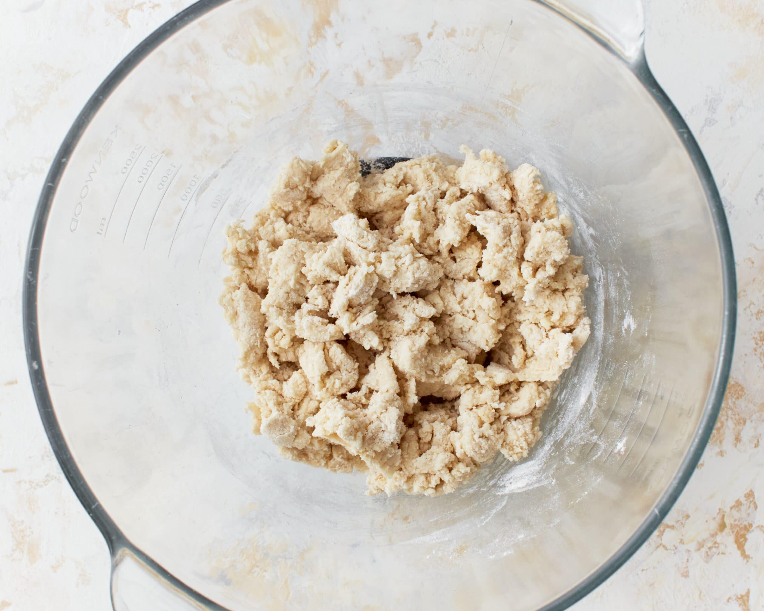 Shaggy gluten-free phyllo dough in a glass mixing bowl.